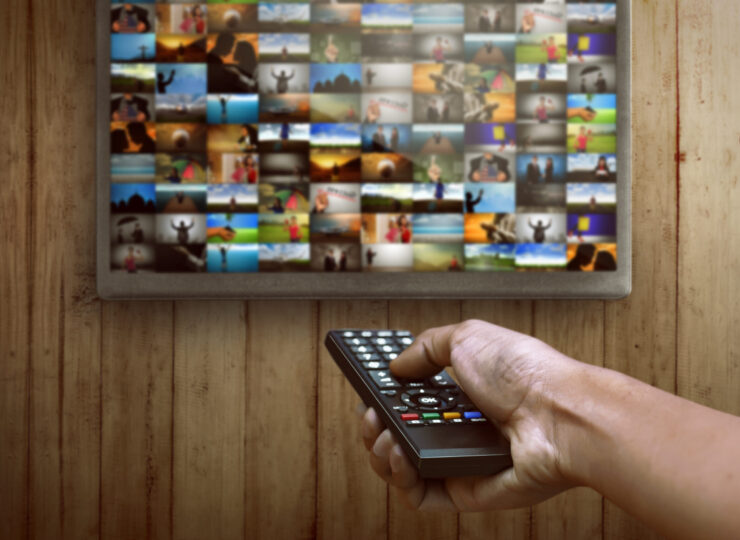 Smart tv and hand pressing remote control