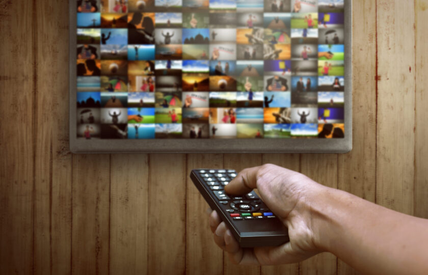 Smart tv and hand pressing remote control